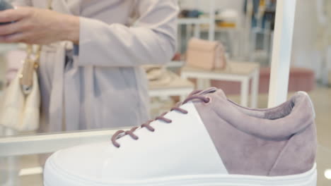 woman shopping for sneakers in a store