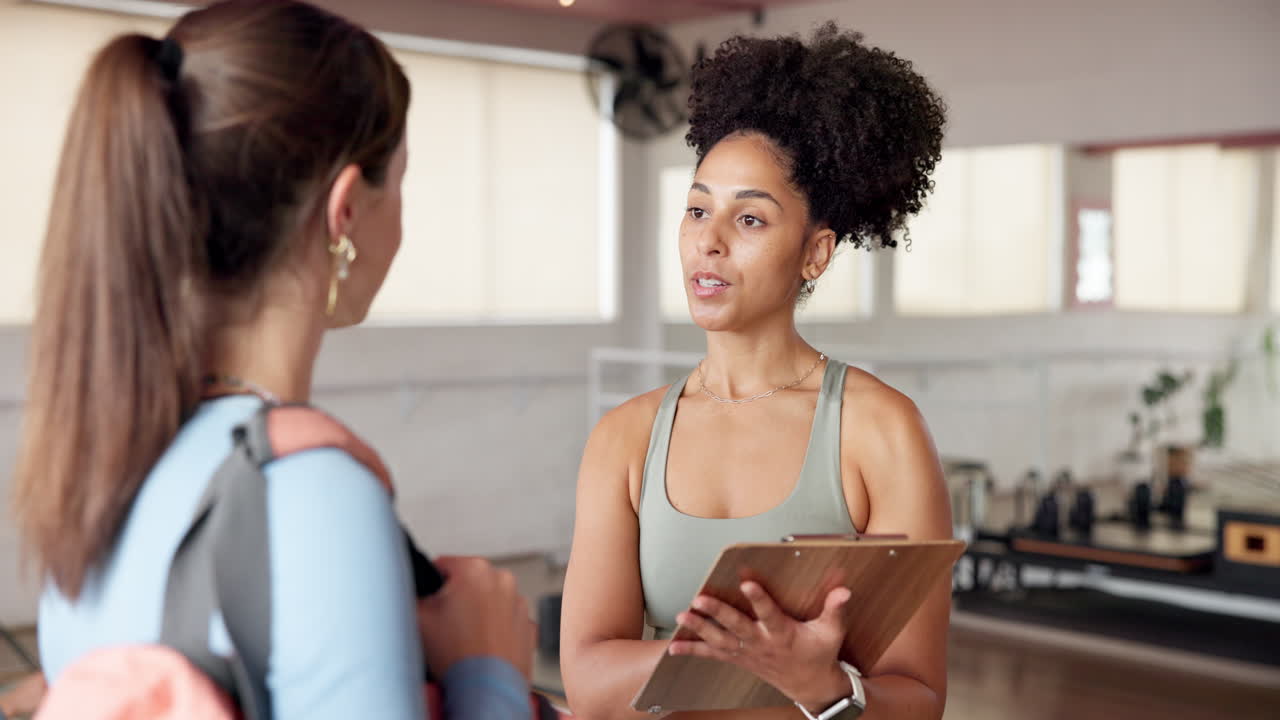 Two women in a gym having a conversation