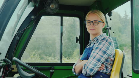 tractor driver woman portrait smiling looking at the camera