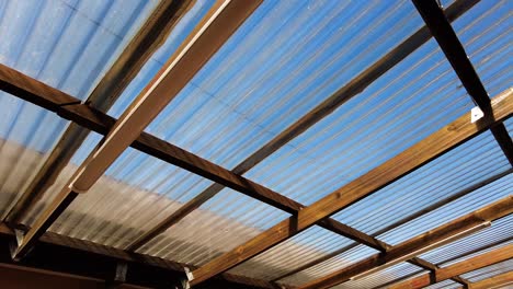 wooden garage with skyview roofing on sunny day