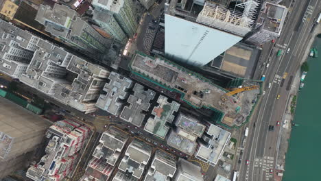 Hong-Kong,-China,-Birdseye-Aerial-View,-Modern-Waterfront-Buildings-and-Evening-Traffic-by-Kowloon-Bay,-Top-Down-Drone-Shot