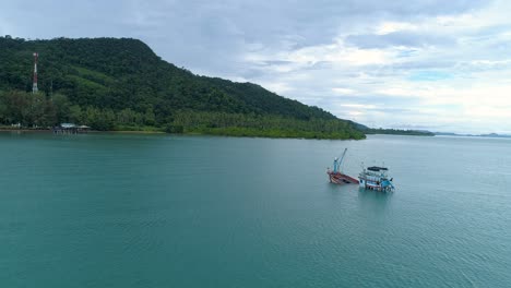 Static-drone-shot-of-a-sinking-fishing-boat