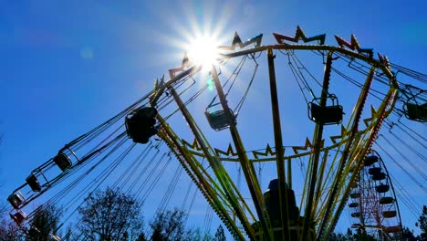 several visitors turn on the chains of the carousel