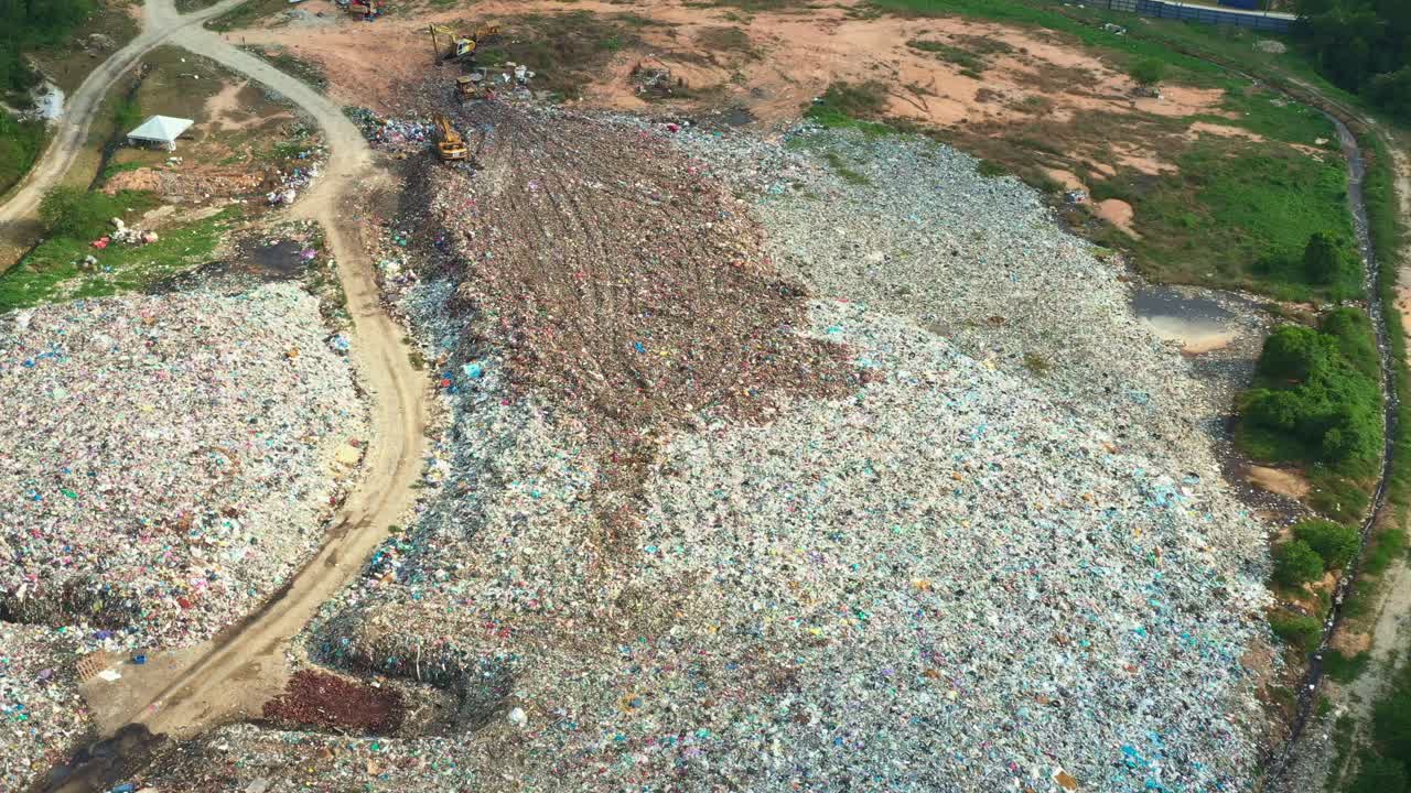 Aerial view, drone flyover Teluk Mengkudu Sanitary Landfill capturing large piles of unsorted solid wastes in the illegal dump site, Manjung Municipal Council, Perak, Malaysia