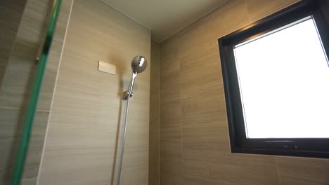 Simple-White-Shower-Head-in-Bathroom-with-Granite-Tile-Wall