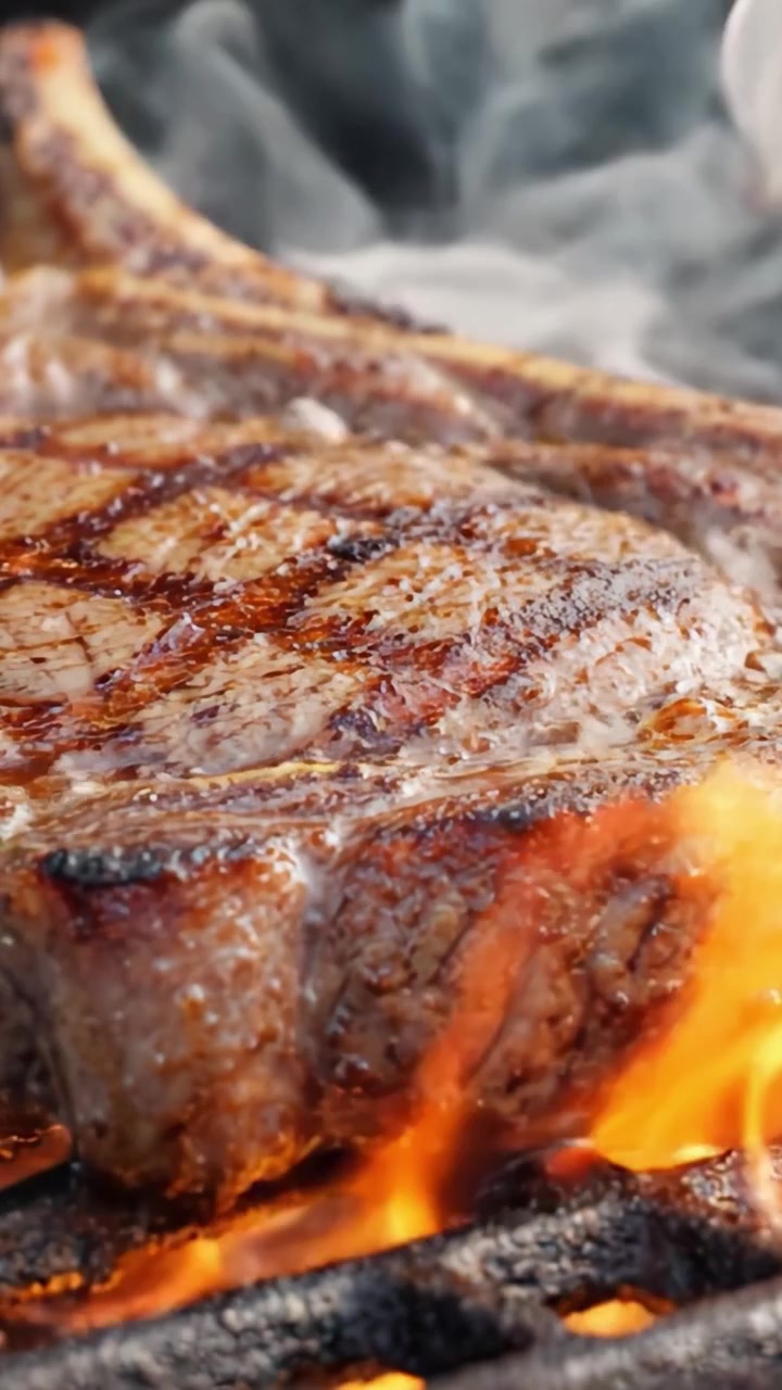 Sizzling Steak on the Grill: A Close-Up View of Juicy Meat Cooking to Perfection with Beautiful Grilling Marks and Flavorful Aroma Rising in the Air