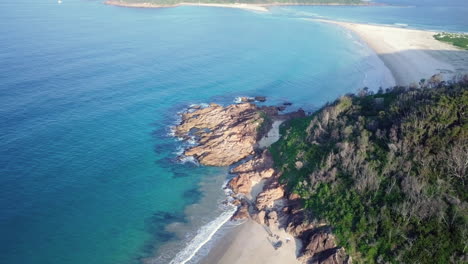 Perfect-light-shining-on-the-rocky-coast-of-Shoal-Bay-in-Australia,-aerial