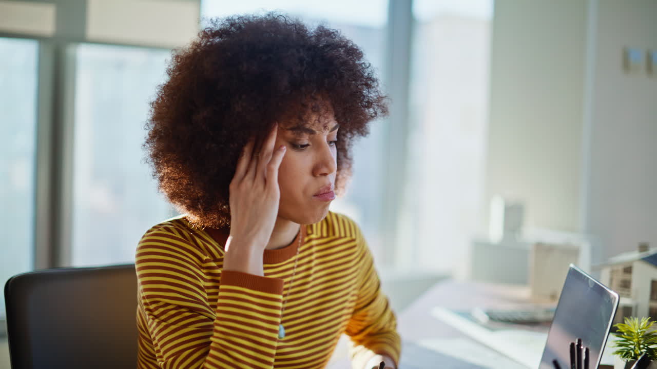 Troubled employee finish call dissatisfied conversation in office space closeup