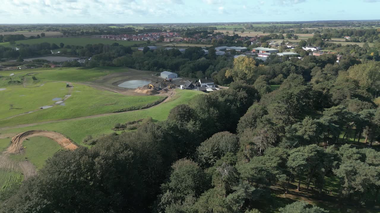 Tætte træer og landby nær Wymondham Kirkegård i South Norfolk District, Norfolk, England.