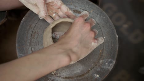 young woman makes a jug of clay. female hands mold pottery