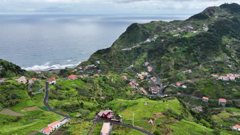 village on madeira coastline in lush hilly landscape