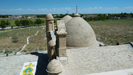 a view of hemispherical roof of arystan bab mausoleum in kazakhstan - aerial panning