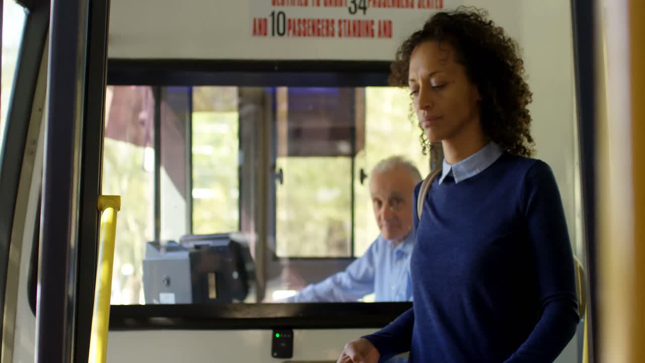 Female commuter using mobile phone while travelling in bus 4k