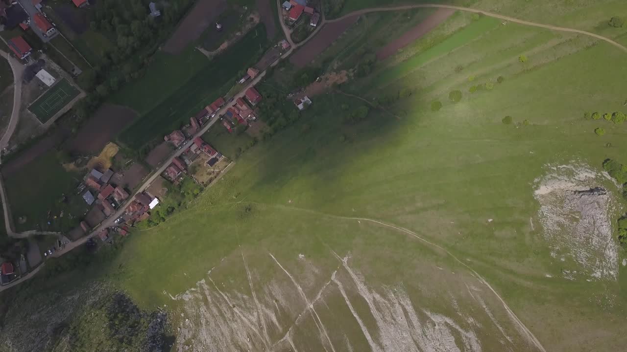 Aerial Top Down View Of Rimetea Village In Romania, Houses Down The Hill On Green Valley
