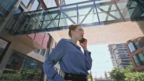 elegant lady calling mobile phone at modern town district. business woman talk