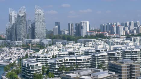 slow motion landscape view of towers buildings resort marina in keppel bay harbour front with singapore city cbd skyline in background asia architecture