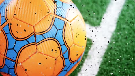 Animation-of-gold-confetti-falling-over-soccer-ball