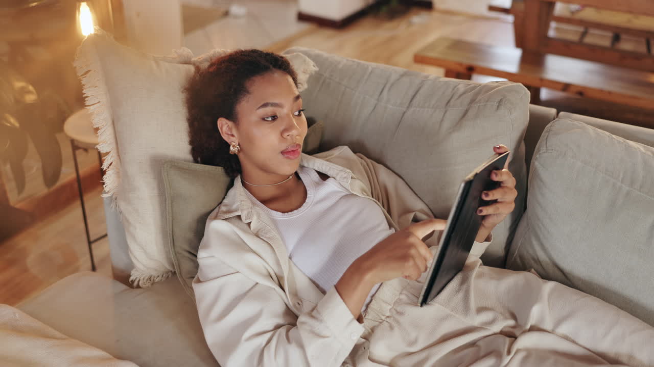 Woman Relaxing on Couch Using Tablet