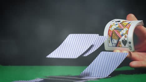 Dealer-distributing-a-cards-on-green-poker-table-with-light-effects