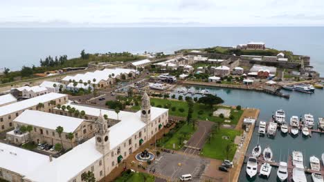 aerial view of tropical island harbour with boats and stone buildings