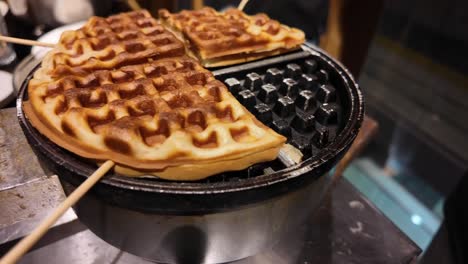 waffles cooking on a waffle iron