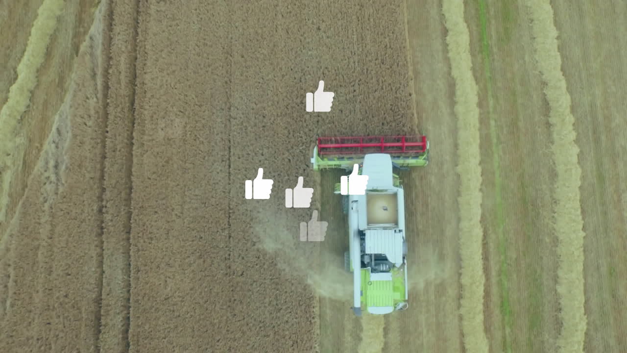 Combine harvester harvesting wheat field, kicking up dust, showing floating white thumbs-up icons