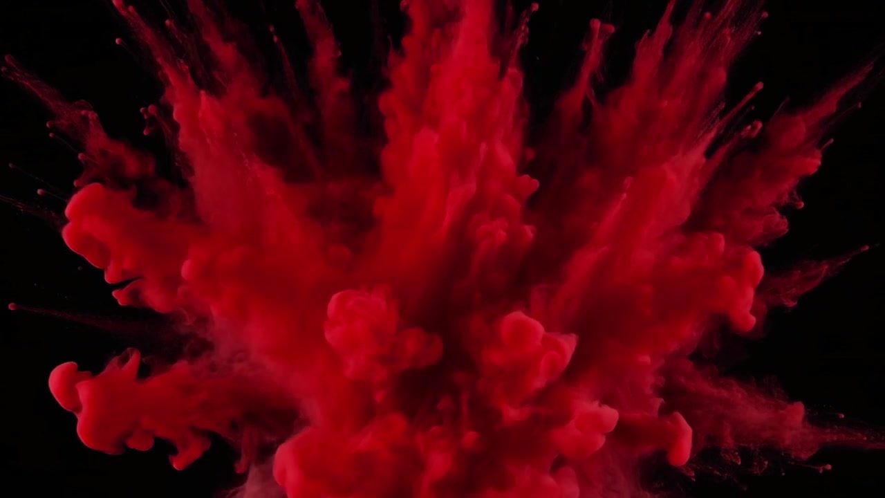 Vibrant Red Powder Explosion Against Black Background