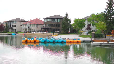 private homes with lake access with boats on a dock in the summer