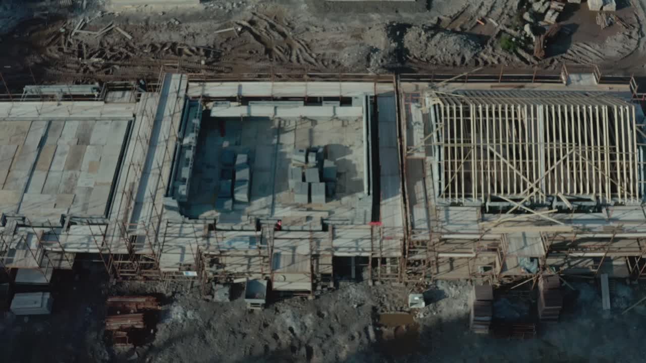 Aerial birds eye view of incomplete building at construction site