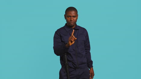 portrait of security agent doing no gesturing with finger, refusing entry