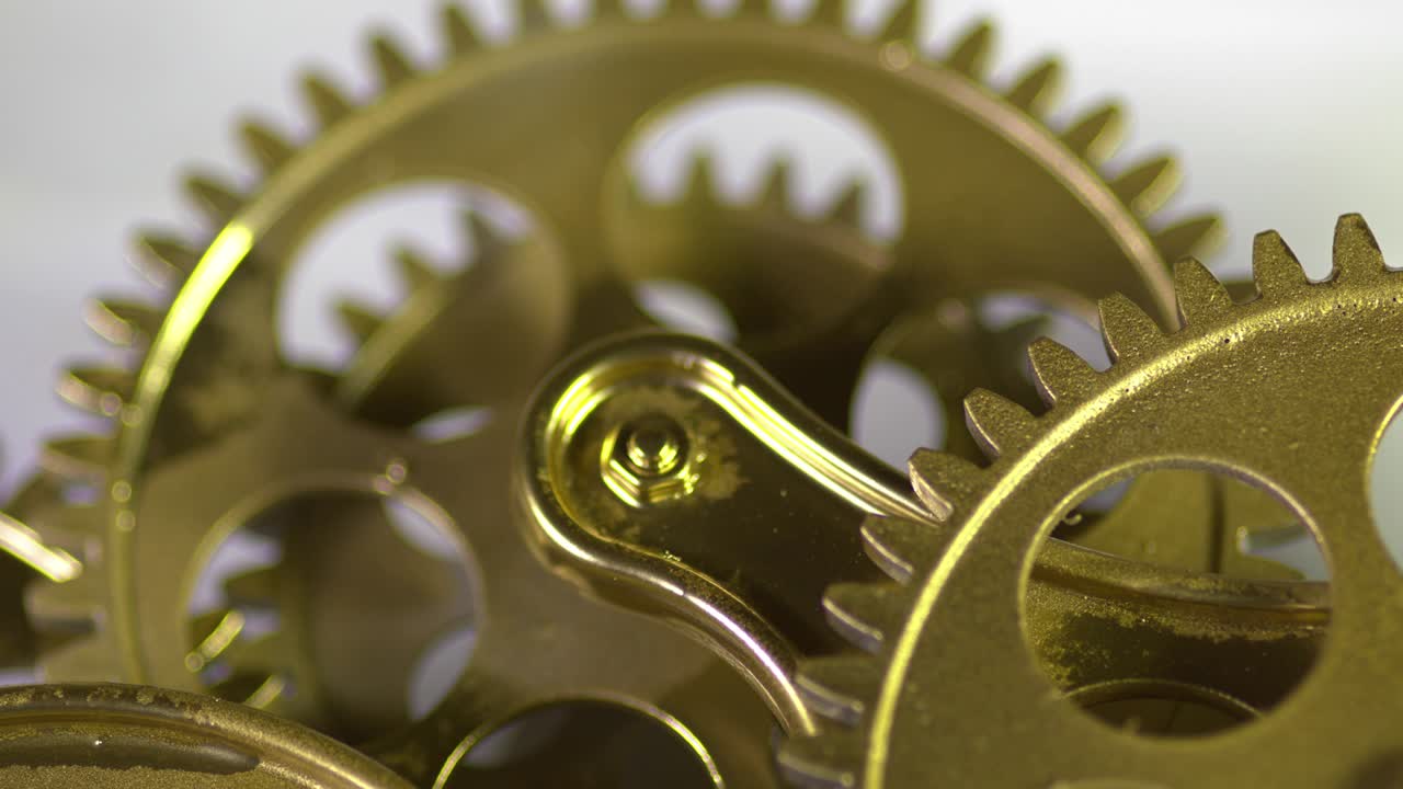 Gold Gilded Metal Gears Working By Rotating