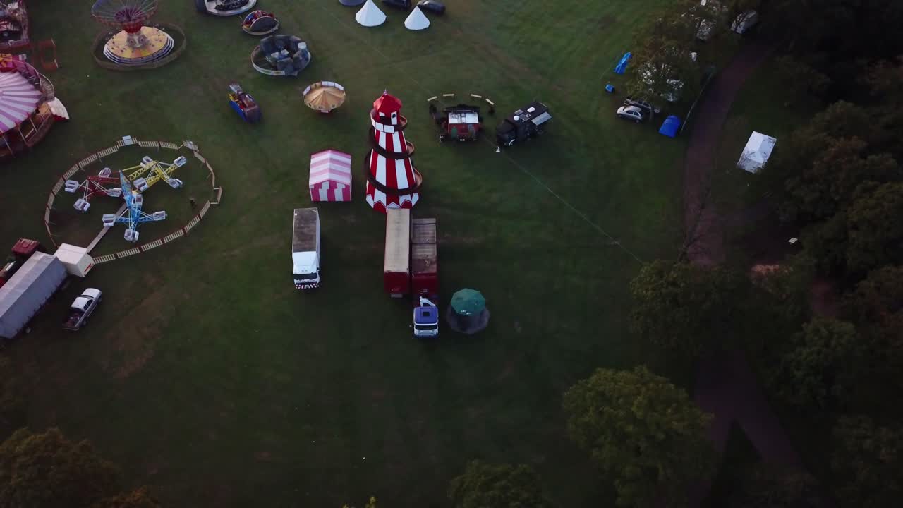 Aerial footage of Silcocks fair. Static shot over helter skelter with single bird flying across shot.