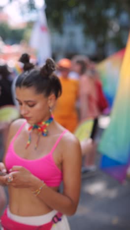 woman at pride parade using her phone