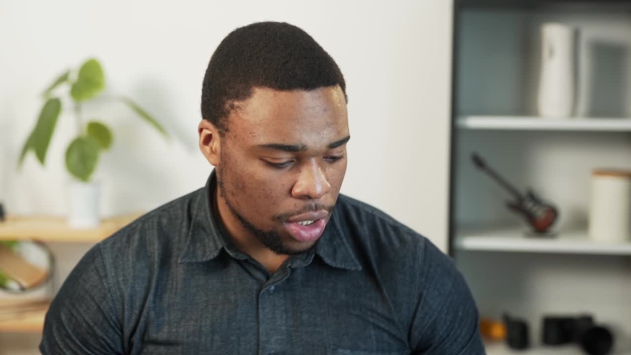 Charismatic African man applies cream on face