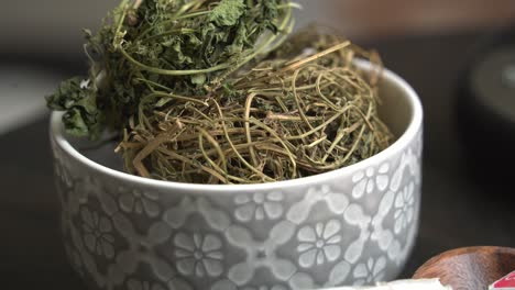 kerala leaves in bowl on table cerasee bitter melon plant with kerala hanging from vines used to make herbal healthy tea good for weight loss