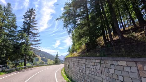 curved road through lush forest and mountains