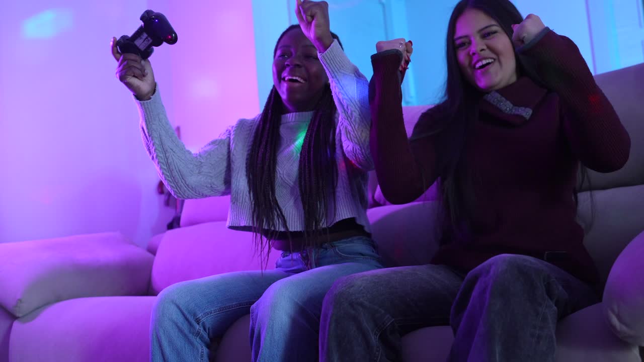 Two teenage girls playing video games together