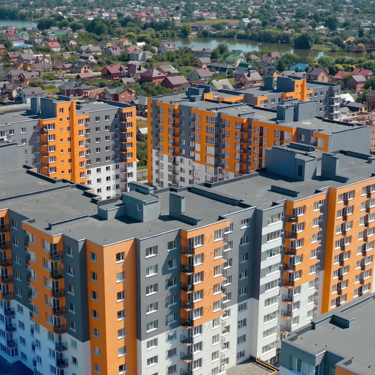 New architecture in the town. Residential cityscape construction. Modern complex of colorful high-rise buildings for residents of the city. Aerial view