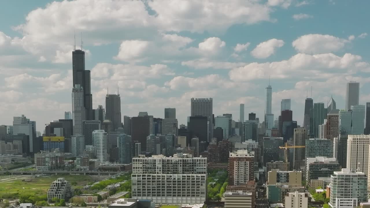 View of downtown Chicago from above during daytime with clouds