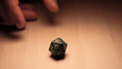 One-D20-dice-is-rolled,-picked-up-and-rolled-again