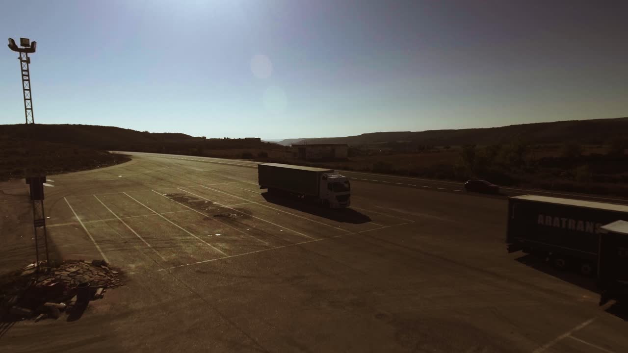 Aerial shot of highway in Spain, cars and trucks driving by