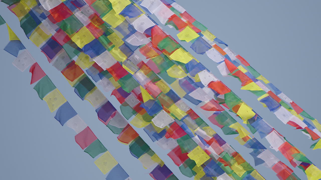 Boudhanath Stupa, Kathmandu, Nepal. Colorful Buddhist prayer flags shine under the sun and flow freely in the wind, symbolizing spiritual peace, calm vibration, and sacred cultural heritage