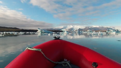 view from a zodiac boat speeding towards icebergs in jokulsarlon glacial lagoon in south iceland