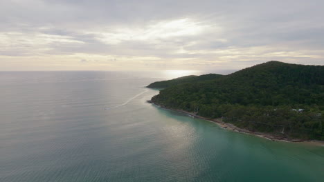 Aerial-Drone-Above-Ocean-Waves-Reflecting-Morning-Sunrise-On-Horizon-Of-Noosa-Main-Beach,-4K-Slow-Motion,-Australia