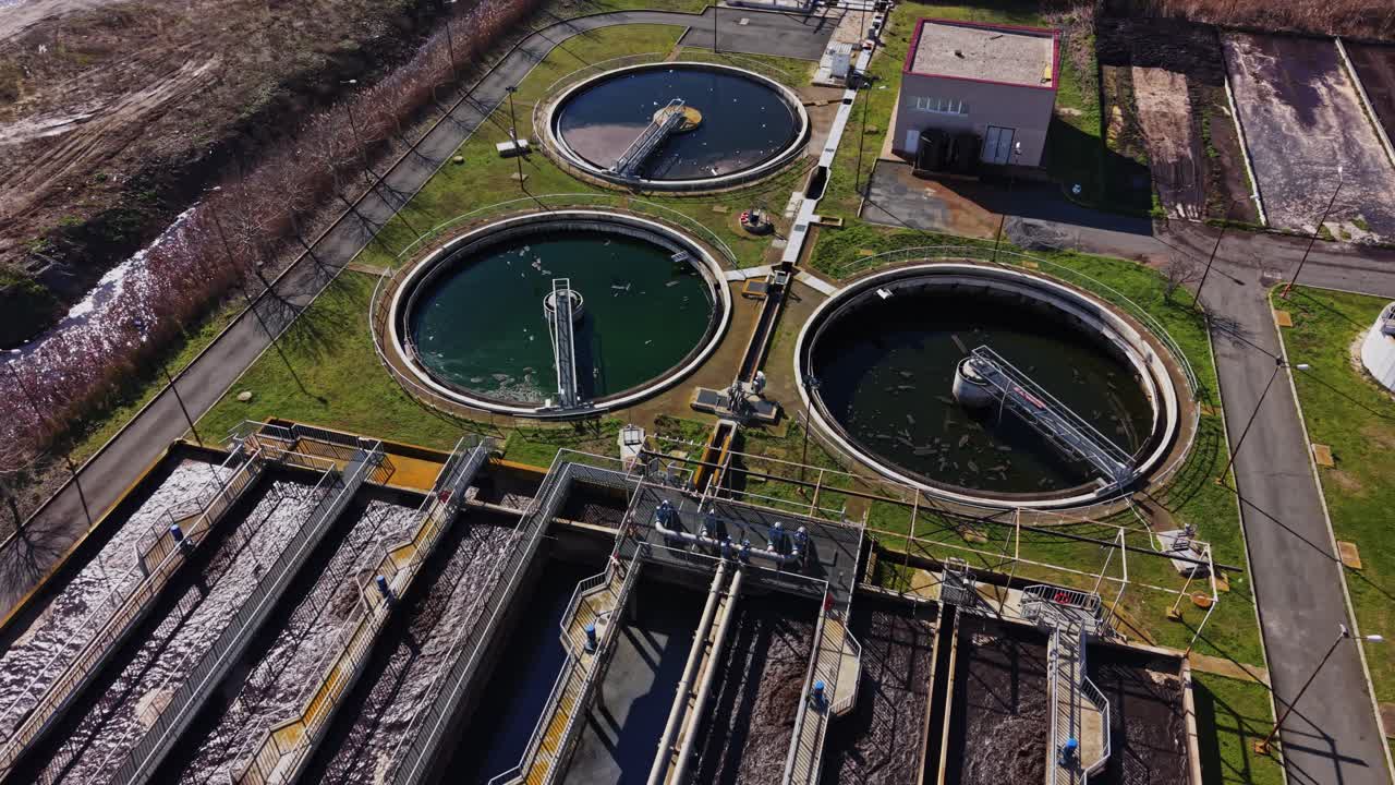 Water treatment facility processing water in circular tanks during daylight