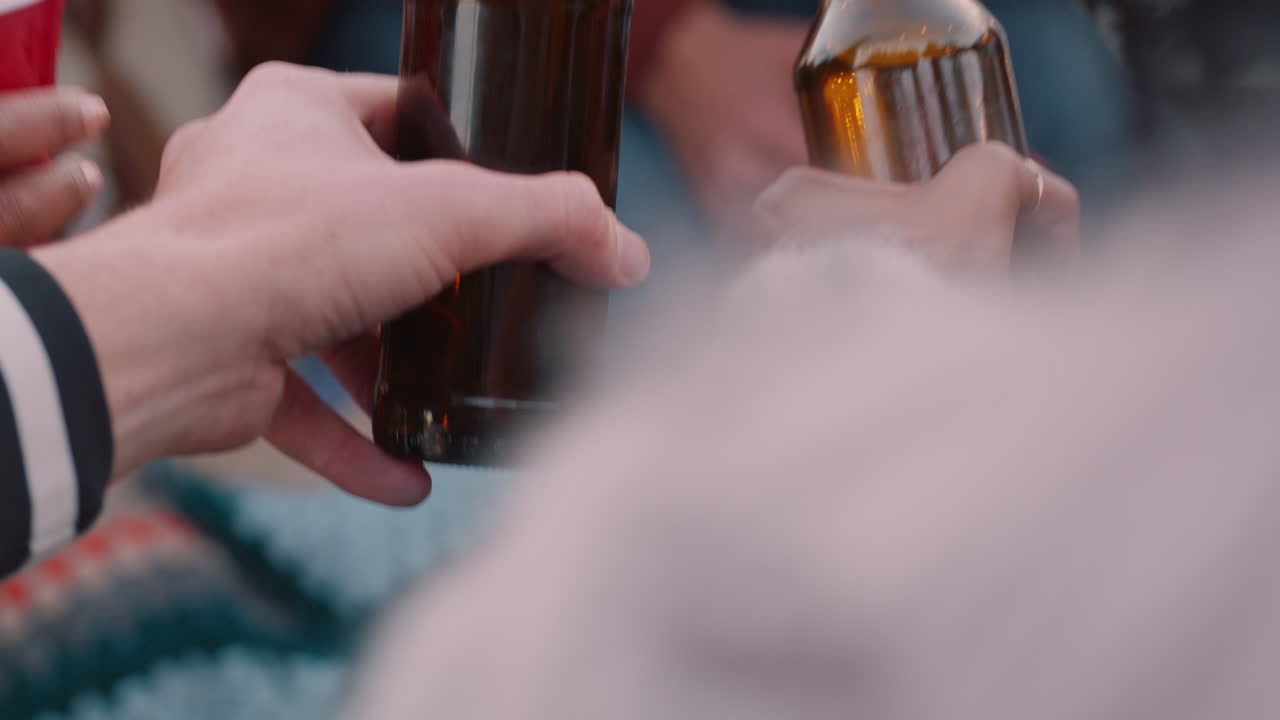 amigos cercanos haciendo brindis bebiendo cerveza disfrutando de una fiesta en la azotea divirtiéndose celebrando la amistad reuniéndose al atardecer