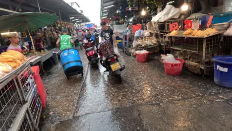 workers moving and cleaning in a wet market