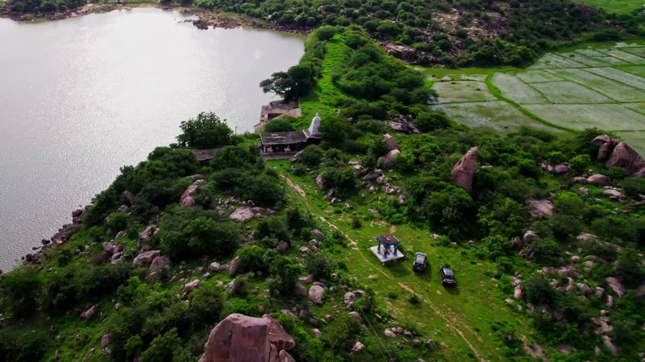 Thumbureshwara Temple with Crop fields lands, greenery and lake at yelupuGonda, Tekmal, Telangana, india. drone shot 4k