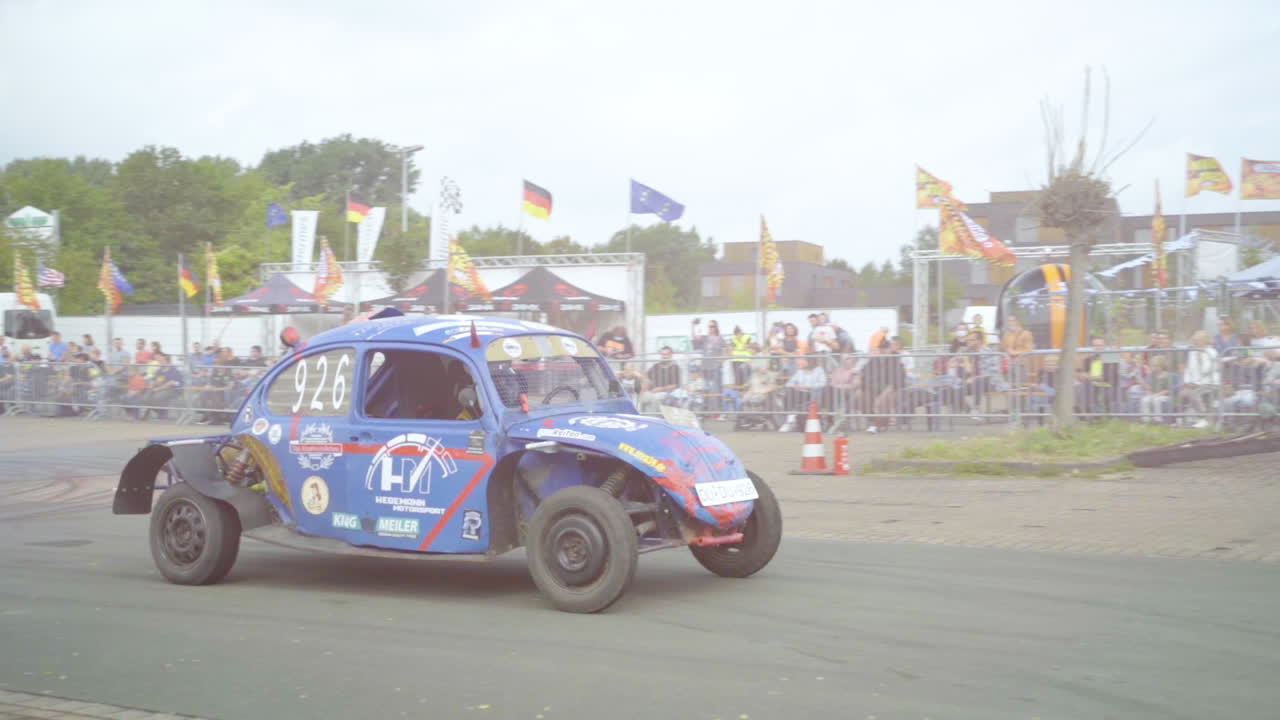Vintage Car With Improvised Engine And Muffler Driving During Car Stunt Show And Exhibition. tracking shot