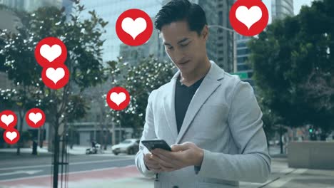 animation of heart shapes floating over biracial businessman using smartphone while standing on road